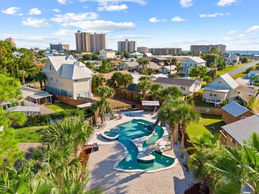 Rare and exceptional investment opportunity located on the East End of Panama City Beach in the desirable South Lagoon area. This 4-bedroom, 3.5-bath, 2,500+ sq ft home is being sold fully furnished and turnkey, with NO HOA and NO rental restrictions.
Situated on TWO lots just a few short blocks from beach access, this 3 story home is designed to maximize both guest experience and income potential. The first floor features a large game room with a pool table, TV and other games, while the main living areas offer ample space, perfect for entertainment and large groups. Step outside and you'll find what truly sets this property apart! The outdoor space is one of a kind featuring a heated custom lagoon style pool with a lazy river, swim up bar, waterslide, and jacuzzi.... all in the shape of a fish. Yes, a fish. Its the kind of feature guests talk about and rebook for. Add in the tiki bar, grilling area, and expansive outdoor space, and you have a private resort right in your back yard. The rear lot is gated and offers road access with a separate entrance, providing ample space for your boat, RV, or jet ski storage. Conveniently located near the public boat ramp with Gulf access, making trips to Shell Island quick and easy. With NO restrictions, the possibilities are endless. Properties with this level of amenities, lot size, and flexibility are extremely rare. This is more than home, its an experience and you don't want to miss out on it!