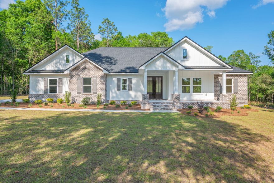 Looking for a custom home we'll look no further. This home sits on a double lot with 2.11 acres and has it all. Open concept w/raised ceiling throughout, large kitchen boasts a mixture of white & wood style cabinets/lower cabinets are drawers for easy storage. Did I mention the hidden butler's pantry w/cabinets and shelving. The home has all black hardware, recessed lighting, quartz countertops, LVP flooring with a touch of tile in owner's bath/laundry. Owner's suit features a tray ceiling, bath has a free-standing tub, tile glass shower, double vanity, & custom closet that connects to the laundry & back foyer. The 3 additional bedrooms all have custom closets, & the bath has double vanity, tub & tile surround. Covered front and back porches are just waiting for rockers and lazy evenings.