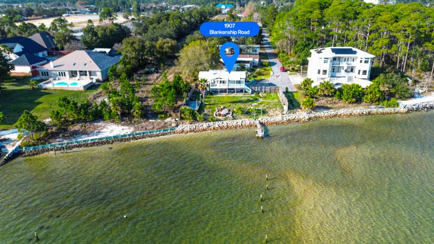 RARE NAVARRE WATERFRONT STEAL-JUST DROPPED $20K!!!
Plus $10K Buyer Credit.
Rare Sound front opportunity on one of the quietest dead end streets in Navarre. Blankenship Rd has only TWO elevated, permanent homes-this one and the long time home next door. Everything else on the street is either vacant land or older mobile/manufactured homes. Giving you privacy, elbow room and almost no neighbors in sight from the water. Just beautiful sunrises & sunsets!
Property Highlights-
108 ft of direct Santa Rosa Sound frontage, dock ready (please see document section for estimates), oversized .38 acre lot, plenty of room for your dream home plus pool and huge dock. AS IS existing elevated modular home with 1344 sq ft, built in 1983, 2 bed, 2 bath plus a bonus room downstairs with its own kitchen and bathroom. Home sits on 8 foot concrete-block stem walls over slab. Keep it, renovate & rent it long or short term. Airbnb- long term rents easily $3800 plus per month seasonally. Or tear down and build your dream home. Enjoy the freedom with no HOA.
County assessed at $445,502 with property taxes for 2025 at $4600/year.
Less than 1 mile to Navarre Beach access & longest fishermen's pier. Located right off HWY 98, you are minutes to dining, shops, top rated schools, grocery stores, biking trails, medical facilities and Hurlburt Field. 
Two perfect buyer paths. One being an investor for a cosmetic refresh on the existing elevated as is modular for quick cash-flow. Two bringing your vision to life with a blank canvas after clearing the site. Create a brand-new elevated sound front estate with second story Gulf views and instant equity potential. 
Imagine morning coffee with these water views or sunset gatherings with friends and family. Boating, kayaking and paddle boarding right out your door, you might even see dolphins and sea turtles! You have sound and Gulf views, perfect to catch the Blue Angels. 
Seller is motivated offering $10k buyer credit toward demolition, dock, closing costs or possible rate buydown. We have tear down quotes ranging from $8500-$10k, dock estimate and insurance/flood quotes. Have peace of mind knowing we also work with several builders experienced in waterfront living. We'd love to make your coastal dreams come true!
Please see the document section for floor plan examples and supporting docs. We tried to supply as much information as possible to help streamline the process.
Comparable cleared sound front lots with less frontage are still asking $650k. Quick close possible. Bring your vision and your offer- this one won't last through spring at this price. Private showings available upon request. 
Back on the market at no fault of the sellers.