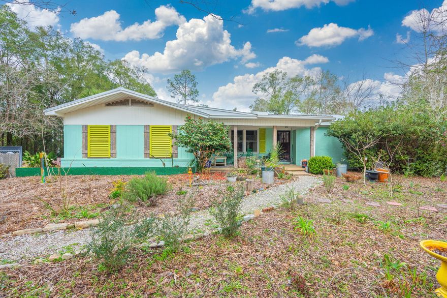 Welcome to your dream home nestled in Oaklawn Square, a charming neighborhood brimming with character and convenience to DeFuniak Springs. This unique property exudes artistic flair and meticulous attention to detail, catering perfectly to lovers of the arts.

The main home, boasting three bedrooms and one and a half bathrooms, showcases an eclectic blend of styles, seamlessly woven together for an elegant yet inviting ambiance. Every corner reflects the owners' personal touch, with original hardwoods throughout and a kitchen adorned with butcher block countertops and open shelving, ideal for culinary enthusiasts. The full bath was renovated in 2025 to include a beautiful claw foot tub. Inside the master bedroom are a set of doors that lead out to a patio. All of the windows in the home were replaced in 2013 along with a new metal roof. 

Stepping outside, discover your own private retreat on nearly one acre of lush land. Wander along trails meandering through the garden, complete with raised beds. Perfect for a guest house, hobby room, office or many other things, is the detached apartment which has a full bathroom and heating and air conditioning while being equally as charming as the main home.