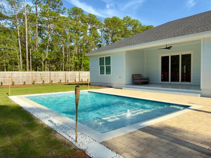 Completed in 2024 and ideally located just north of Hwy 98 with easy access to 30A West, this 4BR/2BA home sits on a spacious ~0.31-acre lot with no rental restrictions. The newly finished backyard offers a private retreat with a pool, paver deck, pergola, and thoughtful landscaping. Inside, the home features 10-foot ceilings, tile flooring, crown molding, and custom trim throughout. A wide three-panel sliding door fills the living area with natural light and opens to the backyard. The primary suite includes a soaking tub, a walk-in shower with a rain head, and a custom closet. Fully fenced with irrigation and a paver driveway. Located ~1.2 miles to Bay Circle Boat Ramp and ~3.5 miles to beach access. Sunlight, space, and coastal charm come together in this beautifully built 2024 home just north of Hwy 98, with easy access to 30A West. Set on a generous ~0.31-acre lot, this property offers the rare combination of privacy, flexibility, and room to breathe, all just minutes from the Emerald Coast's beaches, dining, and boating.
The newly completed private pool and outdoor living area create a backyard designed for relaxing afternoons and effortless entertaining. Surrounded by a spacious paver deck and thoughtful landscaping, the outdoor space feels like your own personal retreat. 
Inside, the home feels bright, open, and welcoming. Ten-foot ceilings, elegant trim details, and large impact windows fill the space with natural light while adding a polished coastal feel. The open living area is anchored by a striking tile-wrapped fireplace, creating a warm focal point for gathering with family and friends.
The kitchen is truly the heart of the home, featuring an oversized quartz island perfect for morning coffee, casual meals, or hosting. It flows seamlessly into both a breakfast area and an additional flexible dining space that can easily adapt to your lifestyle -- whether you envision a second lounge, play area, or entertaining space.
A wide three-panel sliding glass door connects the indoors to the backyard, creating that seamless indoor-outdoor living experience that makes coastal homes so special.
The primary suite offers a peaceful retreat, complete with a freestanding soaking tub, spacious walk-in shower with rain head, and a custom walk-in closet. Thoughtful storage and built-in organization throughout the home add convenience without sacrificing style.
The yard is fully fenced and provides both privacy and curb appeal, with decorative fencing in the front and a six-foot privacy fence surrounding the sides and rear.
With no HOA and no rental restrictions, this property offers flexibility whether you're looking for a full-time residence, second home, or investment opportunity. Located in Flood Zone X, it also offers added peace of mind.
Just 1.2 miles from Bay Circle Boat Ramp and minutes to 30A, this home captures the laid-back coastal lifestyle while still feeling tucked away and spacious.
For boating enthusiasts and investors alike, the location is a major advantage. The home is situated approximately 1.2 miles from Bay Circle Boat Ramp, providing convenient water access to Choctawhatchee Bay. The parcel provides ample space to accommodate boat storage on-site.
Beach access is equally convenient, with the nearest public beach access approximately 3.5 miles away, followed by multiple access points along 30A and Scenic Gulf Drive within about 5.5 miles.
Everyday conveniences are just minutes away:
~1.3 miles to Walmart
~2.6 miles to Publix at Grand Boulevard
~5.1 miles to Silver Sands Premium Outlets
With no rental restrictions, this property is ideally suited for short-term vacation rental investment, second home use, or full-time living. The combination of location, construction quality, luxury finishes, and reduced carrying costs (no flood insurance + no HOA) makes this a compelling, income-producing opportunity at the highest level of the market.