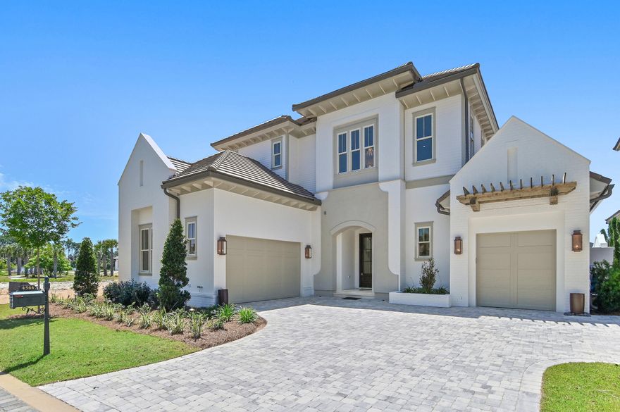 Less than a mile from the beach, this breathtaking new construction home delivers exceptional luxury and striking attention to detail. Welcome to Tradewinds--the newest enclave within Regatta Bay--featuring 54 exclusive homesites inspired by refined West Indies and Dutch-Caribbean architecture. This exquisite residence offers over 3400 square feet of climate-controlled living space with 4 bedrooms, 4 full baths, and 1 half bath. Designed for seamless indoor-outdoor enjoyment, the home centers around a private outdoor oasis complete with a summer kitchen, hot tub and an Alys Beach-inspired pool, creating an ideal setting for both relaxation and entertaining. Inside, the open-concept layout immediately impresses. The expansive living room is anchored by a custom fireplace and flows effortlessly into a chef's kitchen featuring quartzite countertops, a large island, premium appliances, and a spacious pantry with custom shelving. The first-floor primary suite offers serene views and direct access to the outdoor living area. Its spa-like bathroom includes dual vanities, designer lighting, a custom-tiled walk-in shower, and a luxurious soaking tub. A generously sized walk-in closet features custom shelving and built-in his and her storage. Also on the main level is a stylish powder room and a private guest suite with its own bath. The second floor features a large bonus room with a wet bar, laundry room, two guest suites with private baths and a large balcony perfect for enjoying evening breezes. Built by Legendary Home Builders, utilizing only the finest materials and high end finishes such as: wind and impact resistant windows, wind and impact rated doors, insulated wind and impact rated garage doors, insulation in all interior walls for energy efficiency, sound proofing insulation between floors for sound barrier, stainless steel door hinges, custom wood shelving in all closets, Kohler plumbing throughout, custom solid wood cabinetry throughout with soft close hinges, surround sound, smart home technology customizable for homeowner, led lighting throughout and so much more! This extraordinary home captures the essence of modern coastal luxury beautiful, functional, and just moments from the beach. Regatta Bay is a serene, gated community that seamlessly blends golf and boating, offering a lifestyle that is truly unparalleled! The essence of the Regatta Bay Lifestyle revolves around convenience, allowing residents to easily access numerous enjoyable destinations within minutes via golf cart, including the beach! Within the community, residents can indulge in golf, swimming, tennis, pickleball, parks, playgrounds, the Regatta Bay Clubhouse, Legendary Marine, and Legendary Yacht Club. Furthermore, Regatta Bay features a private road that leads directly to the Destin Commons, where an array of popular retail stores for both men and women awaits, alongside a diverse selection of restaurants, Whole Foods, Bass Pro, Lowes, an AMC movie theater, and Uncle Buck's Bowling-all easily reachable by golf cart. Regatta Bay is centrally located offering easy access to the airport and only a few miles from Northwest Florida's finest hospital. Schedule your private tour today and experience the elegance of Regatta Bay living.