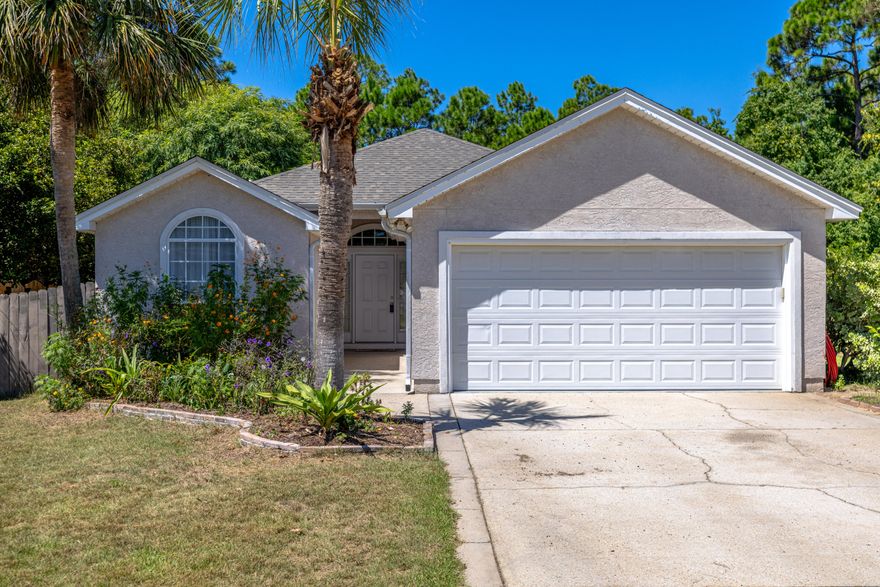 Welcome to Villages at Dolphin Bay - A Gated Waterfront Community on St. Andrews Bay! This sought-after neighborhood offers resort-style amenities including its own private marina with boat slips, tennis courts, and more--perfect for those who love the coastal lifestyle. Step inside this light-filled home featuring soaring 10' ceilings and a bright open floor plan. The spacious family room offers backyard views, surround sound wiring, and sliding doors that open to a covered porch--ideal for relaxing or entertaining. The kitchen has a breakfast bar, white cabinetry, pantry, and appliances. A convenient laundry room and additional storage sits right off the kitchen. The split-bedroom design provides privacy, with each room offering ceiling fans for comfort.  The primary suite features a tray ceiling, spa-like bath with double vanities, cultured marble counters, and a huge walk-in closet. Outside, enjoy peaceful views of the naturally preserved conservation area from your own backyard. Additional features include a spacious attic for storage and an attached 2- car garage. This home offers an incredible opportunity to live in one of the area's premier waterfront communities. --schedule a private showing today!