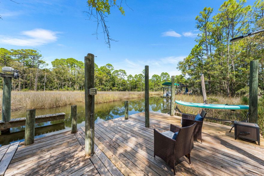 Private dock. Boat slip. Bay access. Gated neighborhood. Set on 82.5 ft of Mussett Bayou, this 5BR home offers direct access to Choctawhatchee Bay via Hogtown Bayou--spend the day at Crab Island and return straight to your own dock. Positioned at the end of a quiet cul-de-sac and backing to a protected conservation area, the setting feels private and removed. A raised walkway leads from the backyard through the preserve to the water, creating a unique, buffered connection to your dock. Inside, the open layout features a spacious kitchen with granite countertops, stainless appliances, wine cooler, and oversized island flowing into the main living area and screened lanai. The home is well-suited for both hosting and everyday living, with formal dining and a dedicated office/study, plus a split-bedroom layout that gives guests their own space without sacrificing privacy. The primary suite is positioned at the rear with direct lanai access and a spa-style bath featuring a jetted tub, tiled shower, dual vanities, and a large walk-in closet.

The outdoor experience is defined by its natural setting--step from the backyard onto a raised walkway that leads through a preserved conservation area to your private dock. From there, enjoy boating, fishing, or easy access to the bay. Spend mornings on the water, afternoons at Crab Island, and evenings back home in a setting that feels quiet and tucked away.

For buyers who value access, privacy, and a more natural setting over direct backyard exposure, this property offers a rare balance within Mussett Bayou Estates.