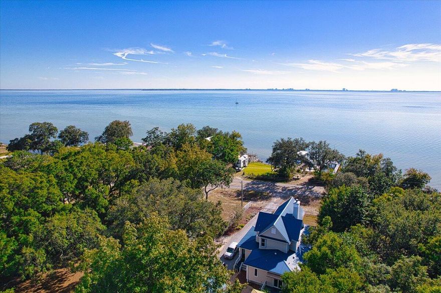 Paradise Found with views of Choctawhatchee Bay and beyond! This home has a Niceville address it is not located in Freeport! Located approximately 2-3 Miles to Bluewater Bay and Mid Bay bridge. Be in Destin in 15 minutes! Short drive to Eglin AFB, shopping, dining! All that is missing is YOU! This meticulously maintained home showcases more than $250,000 in 2020 updates, blending timeless character with modern luxury. High ceilings, triple-crown molding, custom wood trim, a cozy fireplace create an inviting, refined interior. The beautifully updated kitchen features quartz countertops, soft-close cabinetry, custom tilework, and upgraded lighting. All bathrooms have been fully remodeled with high-end finishes. Sunlight fills the home, and nearly every room captures sweeping bay views. Enjoy multiple outdoor living spaces perfect for relaxing or entertaining. A gated paver entry leads to the charming wrap-around front porch, offering the ideal spot to unwind and take in the scenery. This home also has Hurricane shutters, 2020 Roof, 2020 HVAC (2 Units) Controlled access gate to enter the property. Septic was pumped in 2020. The detached 2 car garage has lots of storage and space. There is also a separate smaller metal shed on the back of the lot.
