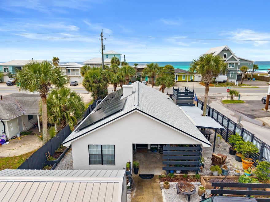 Welcome to this charming beach cottage in Panama City Beach, just steps from the Gulf. Enjoy breathtaking Gulf views and stunning sunsets from your private  lookout deck--perfect for morning coffee or evening relaxation.

Inside, the open-concept floor plan features vaulted ceilings, a cozy gas fireplace, tile flooring, and a beautifully updated kitchen with quartz countertops. The home offers ample covered outdoor living space, ideal for entertaining and beachside BBQs.

The exterior is enhanced with paver accents and includes an outdoor shower for easy cleanup after a day at the beach. Additional features include a 16x20 storage shed and a golf cart for convenient coastal living.

Located only 250 feet from Public Beach Access 76A, this fully furnished property is short-term rental eligible, with projected income potential of up to $70,000 annually. Solar panels provide added energy efficiency and help reduce utility costs.  Average electric bill for the last 12 months $104.00!  All appliances, HVAC, solar panels, roof & water heater are under 4 years old!  Enjoy the convenience of some of Panama City Beach's most popular destinations, including Carousel Supermarket, Thomas' Donuts, McGuire's Irish Pub, and Pier Park--all located approximately 0.5 to 1.5 miles away.

All measurements are approximate and should be verified if important.