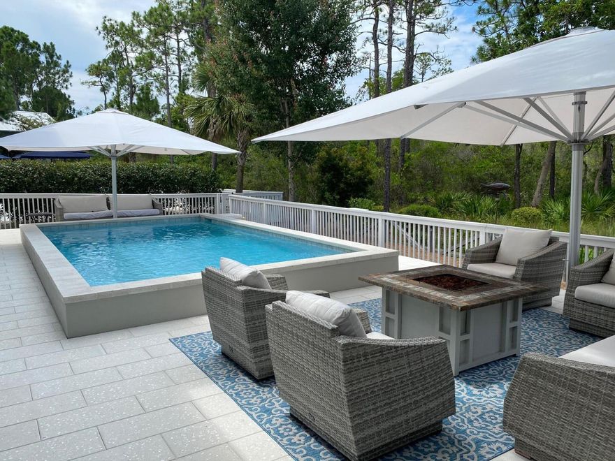 Your NatureWalk Nest Awaits! Experience refined coastal luxury & the pinnacle of coastal elegance in this impeccably curated, move-in-ready retreat, perfectly suited as a private sanctuary or premier investment property. Ideally positioned on a desired lot with easy access to pickleball and amenities within the highly sought-after community of NatureWalk Seagrove, this exceptional residence offers effortless access to the world-renowned beaches of 30A, including Seagrove, Seaside, WaterColor & Grayton Beach along with upscale dining, boutique shopping & vibrant entertainment. Step into your own private resort-style oasis, where a heated saltwater pool, expansive lounging areas, a cozy firepit, outdoor shower, & an inviting screened porch create unparalleled outdoor living experiences. Thoughtfully designed for health, relaxation & recreation the grounds also feature a climate-controlled lockout and a dedicated space for leisure activities. The tranquil backyard showcases serene water views and native landscaping, all bordered by the protected beauty of Point Washington State Forest, offering rare privacy and a true connection to nature. This home lives large & reflects a commitment to both sophistication & wellness, with no carpet & premium engineered wood & tile flooring throughout. The expanded & upgraded chef's kitchen is a statement of style & function, featuring stainless steel appliances, professional 33' refrigerator & freezer units, newly upgraded custom cabinetry, gas cooking, abundant & expansive storage, exquisite finishes, and a warm, inviting hearth. Professionally designed and appointed, the home offers impressive gathering spaces, bespoke finishes, & a grand dining area ideal for entertaining. Guests enjoy a private retreat with scenic views & private outdoor balconies. Additional features include a one-car garage with custom storage and a private driveway with an extraordinary capacity for up to five vehicles--an exceptional luxury in Seagrove! Meticulously maintained and beautifully appointed, this residence delivers a seamless blend of comfort, privacy, and elevated, healthy, coastal living. Private tours are available for this exceptional offering.