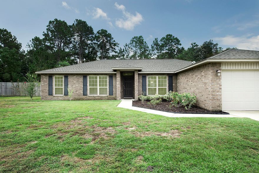 Welcome home to this beautiful ALL brick home in the heart of Navarre. Offering a split floor plan with 4 bedrooms & 2 bathrooms. Home has a nice size kitchen with granite counters, hop up bar, under cabinet lighting, beautiful black stainless steel appliances, large pantry & center island. Sellers added new laminate wood flooring in the entry way, dining, family room & hallways. This home is on an almost half acre lot with an over sized covered back porch perfect for entertaining. Plenty of room to add a pool. Nice landscaping, fully fenced in backyard, with shed & plenty of trees for added privacy. The neighborhood has sidewalks, & is an easy commute to bases and beaches. If you have been looking for a home in East Navarre you want to be sure to add this one to your must see list