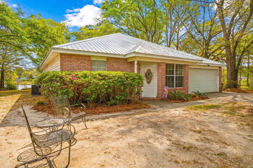 Tucked away on a quiet cul-de-sac, this all-brick 3-bedroom, 2-bath home offers 1,385 sq ft of peaceful lakefront living. With 221± feet on the water and a private dock, it's the perfect setting to unwind. The backyard is simply beautiful--shaded by mature oaks and complete with a fire pit for cozy evenings. The Florida room is a true highlight, and the primary bedroom features its own access for easy indoor-outdoor living. A serene retreat you'll love coming home to. Peaceful, private and move-in ready- this home is a rare find! Call to schedule your tour today!