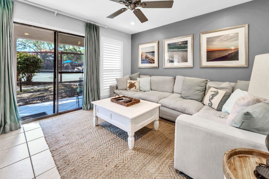 NICELY UPDATED with Tennis views!  Welcome to Tennis Village located in the private, gated community of Tops'l Beach Resort. This unit is being sold fully furnished and turnkey ready. The unit boasts two covered porches and a private, open air deck. As you head inside the property through the covered carport, you are greeted by the open living space of the kitchen, dining room, and living room. The kitchen has all stainless steel appliances and quartz countertops. There is no carpet to be found anywhere in the unit, providing for easy maintenance. Off the living room is the first covered porch with direct views of 2 of the 12 Rubico clay tennis courts. The setting must be seen to be believed! You will also find a half bath and owners closet on the first floor.

Headed up to the second floor soon you will discover that luxury vinyl plank flooring has been installed and both bedrooms have been recently painted. Both bedrooms upstairs have their own private bathrooms. The guest room located on the front of the unit has access to the private, open air deck, perfect for sunbathing, or just enjoying a little bit of privacy outside. The attached private bathroom has a shower/tub combo.
The primary suite located toward the back of the unit has access to the second covered porch overlooking the tennis courts. The master bathroom features a double vanity, and floor to ceiling tiled shower with sitting bench.

Being in the community of Tops'l Beach Resort, you have access to 600 feet of private beach, onsite rental management, world class tennis and fitness center with an indoor/outdoor pool, tram service to the beach, and onsite restaurant. Tops'l is located on the outskirts of Miramar Beach, only a short distance from dining and shopping at Silver Sands Outlet Mall, Grand Boulevard, Baytowne Wharf, and so much more.