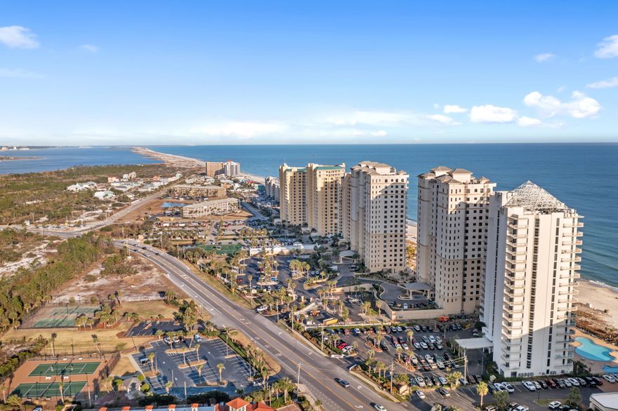 Discover your beachfront paradise at Indigo #803W, where coastal luxury meets breathtaking Gulf views on Perdido Key. The elevator will open at your 8th floor location where you will enter your private foyer before stepping into this beachfront oasis. Furnished with coastal décor & touched with true coastal elegance, this 3-bedroom, 3-bath condo is not a vacation rental, but holds the potential to be an income producer or remain a secondary residence. The open-concept layout invites you to soak in panoramic Gulf views through floor-to-ceiling windows. The fully updated kitchen shines with quartz countertops, stunning backsplash, stainless steel appliances, custom cabinetry with smooth glide pull-out shelving, & space for serving & entertaining guests. The spacious dining & living area show cases the Gulf where you have direct views overlooking the beautiful beaches. The primary suite, with direct views of the emerald waters, is an escape like none other. Step onto the beachfront balcony accessible from both the living area & primary suite, a place to enjoy a book, a beach view & the Gulf breeze. Two additional bedrooms, designed as secondary suites, provide their own slice of paradise, each opening onto a shared north-facing balcony with breathtaking views of the Intracoastal Waterway. You truly have the best views of both worlds. Designed for effortless coastal living, this residence offers both comfort & convenience with covered parking, a climate-controlled storage unit ideal for beach gear, & a recently replaced water heater (2021). Indigo, a gated 6-acre beachfront resort, features an impressive lineup of amenities including elegant lobbies, owner's community rooms, a newly updated fitness center, a movie theater, tennis & pickleball courts, a zero-entry pool, & a relaxing hot tub. Located across from dining & shopping, this condo presents an exceptional opportunity for a personal retreat or an income-producing investment. Your place on the Gulf awaits!