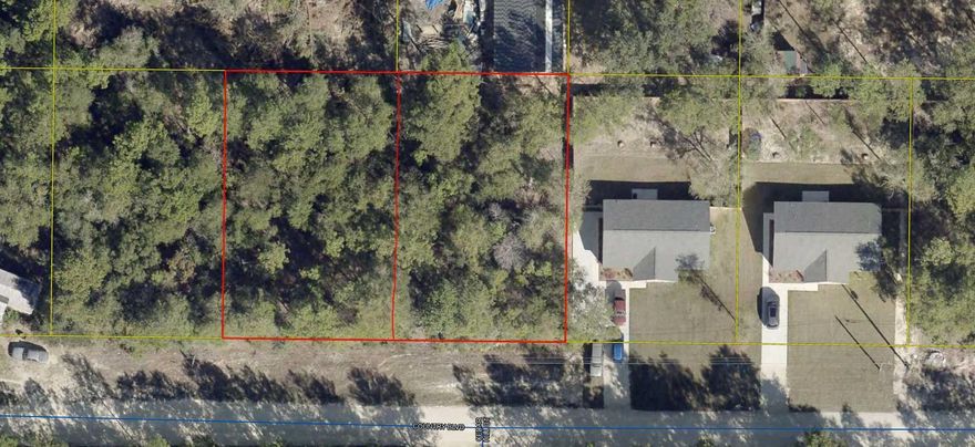 Wooded lot  80'x125' you can almost see Hwy 90 W in DeFuniak.  Located off Girl Scout Road.  
City water available, tap fee not paid.  Several new homes being built in this area.  Mobile homes allowed.