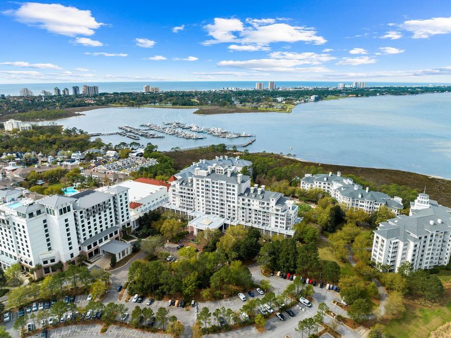 The lowest priced furnished 2BR with a NEW HVAC in 2026 in The Grand Sandestin, a popular conference center located in the bustling pedestrian village at the Village of Baytowne Wharf. A light and bright coastal decor encourages relaxed living inside a 10th floor penthouse level retreat with unparalleled panoramic views of the bay, peaceful sunrises, the golf course and more. A spacious balcony of over 107 square feet makes outdoor living enjoyable. Sandestin projects rentals of up to $53,969 annually based on similar rental units, but this unit has never been rented and is meticulously maintained as a primary residence. With only four units occupying this exclusive floor, privacy and tranquility are assured, and there are only five units with this floor plan. Providing an intimat escape amidst Baytowne Wharf vibrant ambiance. This exceptional residence, presents an unparalleled opportunity for discerning buyers seeking a second home, an investment property, or a primary residence with the added allure of personalization. The heart of the home is a spacious and luminous open-concept layout seamlessly connecting the kitchen, dining area and living room, creating an inviting space ideal for lavish entertaining. Modern conveniences abound, with stainless steel appliances including a new refrigerator and professionally painted cabinets in 2025. A gourmet kitchen and sleek charcoal granite counters providing both style and functionality. A laundry space sized perfectly for a stacked front loading washer and dryer is tucked away in a closet off the kitchen. This turnkey residence boasts an array of upgraded amenities, including custom window coverings, an electronic digital lock on the entry door for added security and additional electrical outlets strategically placed for enhanced convenience. It also had fresh paint including walls, trim and ceilings in 2023. Ensuring utmost comfort and functionality, the windows in the bedrooms and living areas have been expertly maintained to allow seamless operation, while new window screens have been installed, allowing for refreshing cross-breezes to permeate the space. An underground garage space is assured as well as storage cage in the garage for outdoor gear. Beyond the confines of this exquisite residence, residents of the Grand Sandestin are invited to indulge in a wealth of luxurious amenities, including a heated pool and hot tub for relaxation, a fully-equipped fitness center for maintaining an active lifestyle, and a convenient commercial laundry room for handling larger items. Residents will enjoy privileged access to an array of resort amenities and recreational activities that make Sandestin a coveted destination for all seasons and all ages. Meet the Sandestin beach tram at The Grand Sandestin porte cochere for a quick and easy ride to the beach. In the Village of Baytowne Wharf, residents can explore a diverse array of seasonal events, dining, shopping, and entertainment options, ensuring there's always something to delight every palate and preference. Sandestin Golf and Beach Resort stands as a beacon of luxury and leisure along Florida's Emerald Coast, spanning over 2,000 acres and encompassing more than 70 unique neighborhoods, each offering its own distinct charm and character. From pristine beaches, multiple day spas, championship golf courses, a world-class tennis center and year-round events at the Village of Baytowne Wharf, Sandestin offers an unparalleled array of amenities and activities to suit every lifestyle and preference.