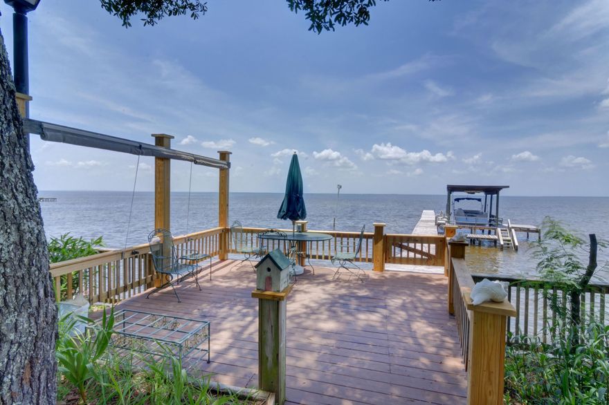 *100ft waterfront with a seawall, dock, and covered boat lift on East Bay* Paradise Found! There is truly nothing like waking up to the view of the bay outside your window, and this rare find will make that dream a reality! Enjoy the best of Florida living on your 0.67 acre lot and fish right from your backyard, or take your boat out for a sunset cruise whenever you like. This impeccably maintained and loved home has a long list of seller upgrades and updates, and has been completely remodeled from the original block home to the spacious updated beauty you see today. It features four bedrooms (two of which are massive master suites), and three full baths with a spacious 22x25 living room that showcases a stunning bay front view that will take your breath away! Add- itionally, enjoy a separate formal dining room, interior laundry, and a bonus room that could serve as a bedroom, office, playroom, storage, or a mulitude of various purposes. Out front is a combination workshop (with full power) and storage shed, and out back is where you'll find the stunning view that you'll be yearning to come home to. 100 feet of bayfront access await you with a recently rebuilt seawall, patio leading to the dock, a covered boat lift, extended pier, above ground pool, outdoor shower, and most importantly - your perfect spot to soak in the Florida sun and treasure the beauty of the bay. Don't miss out on bayfront living on this quiet street off East Bay Blvd, and start living your best Florida life! (note: home has NEVER flooded, due to recent upgrades homeowner's insurance only $1575/year!)