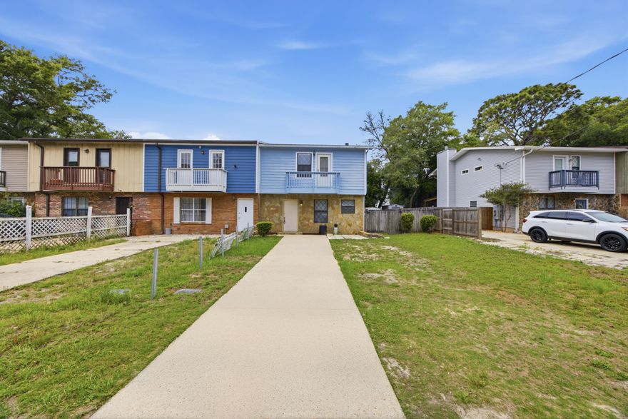 Located between Eglin Air Force Base and Hurlburt Field, this updated corner-unit townhouse offers convenience to military bases, schools, shopping, dining, the airport, and the white sand beaches of the Emerald Coast. The layout includes a half bath downstairs and a full bathroom for each bedroom upstairs, creating a practical setup for shared living while still offering privacy. The primary bedroom features a private walkout balcony. As a corner unit, the property has an extended fenced backyard with additional space for a storage shed, garden, or outdoor recreation area. Ideal for owners needing extra outdoor space for pets or entertaining. Major systems information and insurance quotes are available through the listing agent.