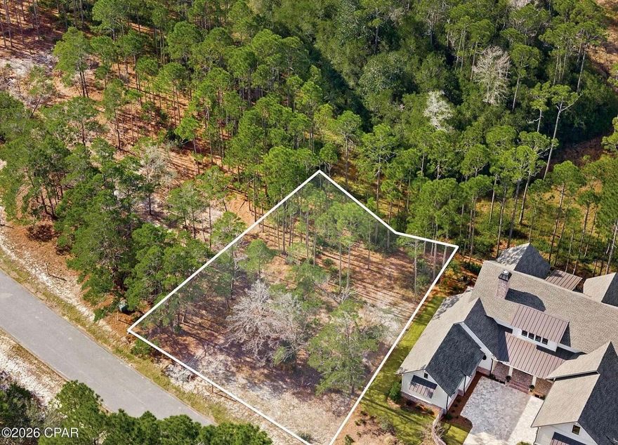 This beautifully wooded homesite located in Wild Heron Coastal Sanctuary is perfectly positioned on a quiet cul-de-sac that overlooks the 8th green of the Greg Norman-designed Shark's Tooth Golf Course, offering peaceful views and exceptional privacy with a golf course buffer behind the lot. Residents enjoy resort-style amenities including a lakefront pool, fitness center, boathouse with dock access to Lake Powell, kayak and paddle board storage, walking trails, parks, and community gathering areas. Golf enthusiasts can also enjoy the renowned Shark's Tooth Golf Club, available through Watersound Club membership. Ideally located just minutes from the Gulf of Mexico and Scenic Highway 30A.