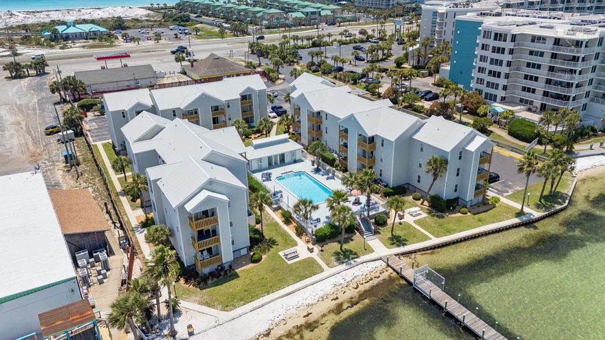 Imagine waking up to scenic, peaceful bay views and knowing that your boat is parked just steps away at a brand-new, premier marina development. This move-in ready Okaloosa Island condo delivers the exact coastal lifestyle buyers are searching for, offering rare boat parking and effortless access to the water. From this prime location, you can spend your afternoons taking a short boat ride to the famous Crab Island or driving minutes to dip your toes into the Gulf's sugar-white sands. Overlooking the tranquil Choctawhatchee Bay, this beautifully refreshed unit offers total peace of mind and effortless style. The updated interior includes granite countertops, fresh paint, new furnishings, and a new HVAC system. Designed for both entertaining and unwinding, the bright open-concept layout seamlessly connects the living, kitchen, and dining areas. With two spacious bedrooms and two bathrooms, the property comfortably accommodates owners and guests alike. Outdoor enthusiasts will find endless ways to enjoy the waterfront location. Bring your fishing gear and cast a line off the private dock, relax by the sparkling pool, or simply soak in the sunset. Perfectly situated in the heart of Okaloosa Island, this property is moments from endless recreation including parasailing, jet skiing, dining, and shopping. Whether you seek a primary residence, a seasonal getaway, or an investment opportunity, this property delivers the absolute best of Florida living.
