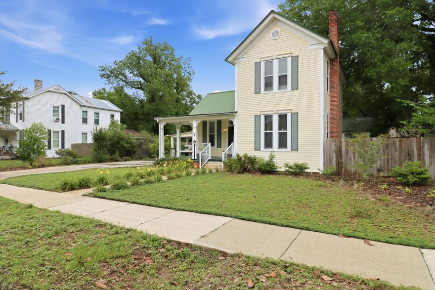 Step into a piece of history in the heart of DeFuniak Springs, where timeless character and Southern charm come together in this beautifully preserved historic home. Nestled beneath mature trees, this inviting property offers the perfect blend of warmth, charm, and classic craftsmanship. Located just moments from the iconic lake yard, local coffee shops, boutique shopping, and downtown favorites, this home captures the essence of true small-town living while offering the character and atmosphere that make historic homes so special.
A versatile bonus room connected to the home offers endless possibilities and could easily serve as an art studio, butler's pantry, home office, reading room, or creative space. Outside, a detached storage building adds even more opportunity and could be transformed into a gardening shed, workshop, hobby space, or potential mother-in-law suite. Situated on an oversized lot with a fully fenced backyard, this property provides the space, flexibility, and charm to truly make it your own.