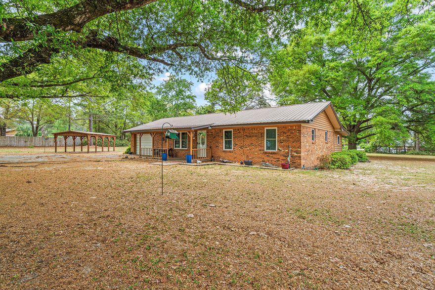 Bring your horse to this beautiful country home that is in a great location.  It is south of the interstate on Coy Burgess Loop so you are close to Freeport and the beaches.  This beautiful brick home with a metal roof has 3 bedrooms 2.5 bathrooms, garage, and large sun room overlooking the back yard.  The yard is fully fenced with two horse paddocks, run in shed, and a building with water and electricity and a horse stall. The property is bordered by 3 roads so you only have one neighbor in the backyard.