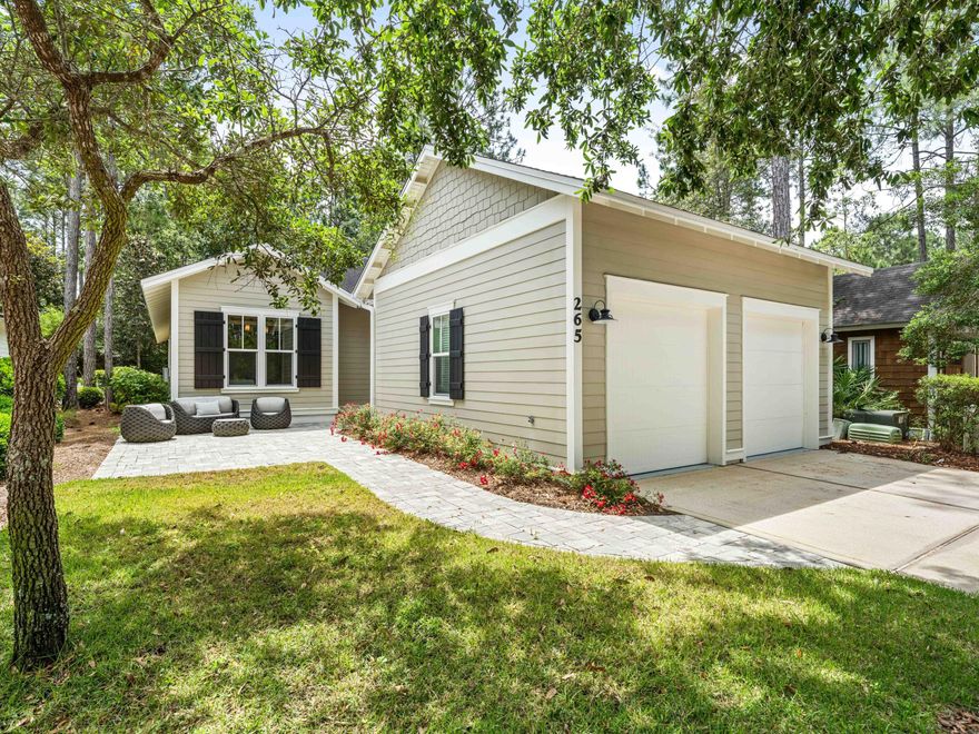 Positioned within the mature landscaping of Watersound Origins, this meticulously renovated four-bedroom, three-bathroom residence spans 2,214 square feet and exudes a sense of spaciousness that belies its footprint. A tranquil green space situated behind the home offers a rare level of privacy, particularly in this price range.
The interior has undergone a comprehensive transformation, featuring updated hardwood flooring, shiplap accent walls in all bedrooms, window treatments, and decorative lighting. The expansive living area boasts wood paneled walls and an open floor plan that seamlessly transitions into the renovated kitchen. The kitchen is equipped with quartz countertops and backsplash, custom cream raised-panel cabinetry, an undermount sink with brass plumbing, and new refrigerator and stove. A spacious island provides seating for four and houses a dedicated icemaker.
A renovated wet bar, complete with custom cabinetry featuring glass fronts, open shelving, backsplash, and built-in wine and beverage refrigerators, facilitates effortless entertaining.
The laundry area has been updated with new cabinetry, a herringbone backsplash, quartz countertops with under-cabinet lighting, and a new coffee station, ideal for starting the day. The pantry has been enhanced with designer wallpaper and tile flooring.
The primary suite, located at the rear of the home, is strategically positioned to fully enjoy the green space, featuring a shiplap accent wall, direct access  to a well-appointed walk-in closet, and an updated bathroom with new dual vanities adorned with gold fixtures, mirrors, tile, designer wallpaper, and a glass-enclosed tile shower. An additional guest bedroom includes its own ensuite bathroom with a new vanity, tile and mirror. Another guest bedroom shares an updated full bathroom with the fourth bedroom, which is currently serving as an office.

The screened porch provides a functional outdoor space for year-round living. A new paver patio with ample seating on the front of the home is an ideal spot for relaxation and enhanced landscaping features boxwood hedges. The two-car garage includes attic storage above, and a private outdoor shower provides an easy rinse after a day at the beach.

Watersound Origins offers residents the perfect combination of natural beauty and modern amenities. Surrounded by towering pines and Lake Powell, the community is only two miles from the vibrant beaches of Scenic Highway 30A. The Village Commons serves as the neighborhood hub, featuring a resort-style pool, fitness center, playground, pickleball and tennis courts, and an event lawn. Residents enjoy access to the highly rated Origins Golf Course, scenic walking and biking trails, Lake Powell access, and an upcoming Art Park. Additionally, the Watersound Town Center at the entrance to the community offers dining, shopping, a Publix grocery store, medical facilities, and more.