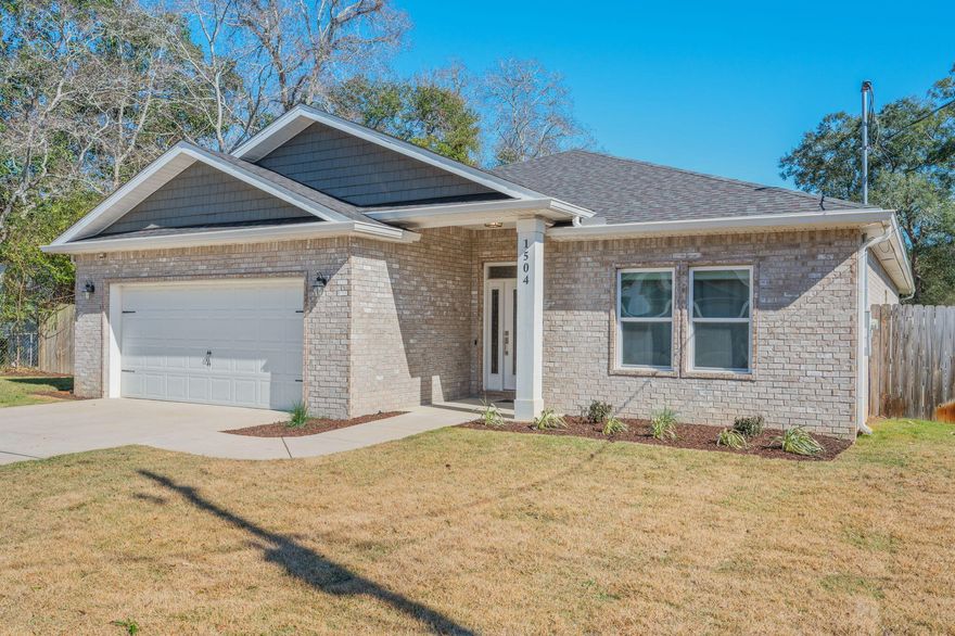 Fort Walton Beach living at its best -- bases close, beaches closer, and a home that delivers the moment you walk in.  Step inside and the home announces itself immediately. A wide, welcoming foyer opens into a long hallway that draws you forward -- and then the space unfolds completely. The living room, kitchen, and dining area connect in one expansive, light-filled open concept that simply doesn't feel like its price point. The two-tone kitchen stops people mid-tour -- white upper cabinets, navy lowers, a granite island with seating, and pendant lighting that works as hard at breakfast as it does at dinner. Barn doors, tray ceilings, and crown molding throughout give the home a level of finish that stands apart in this neighborhood. 
The floor plan is equally well thought out. The primary suite occupies its own wing -- a true retreat, completely removed from the rest of the household. On the opposite end, additional bedrooms, a flex space, and a dedicated laundry room give every member of the household room to function independently without the home ever feeling crowded. Step outside and the backyard is fully fenced, private, and genuinely usable -- covered patio, open patio, and an irrigation system keeping the lawn effortless year-round. The location ties it all together. Hurlburt Field, Eglin AFB, and Duke Field are all within easy reach --and Duke Field commutes run counter to peak traffic flow, a quiet advantage that adds up every single day. The beaches of Fort Walton The beaches of Fort Walton and Okaloosa Island are just minutes south. Shopping, dining, and everyday services are all within the same comfortable radius. Space, design, location, and a price that makes it possible. This one is worth the appointment.