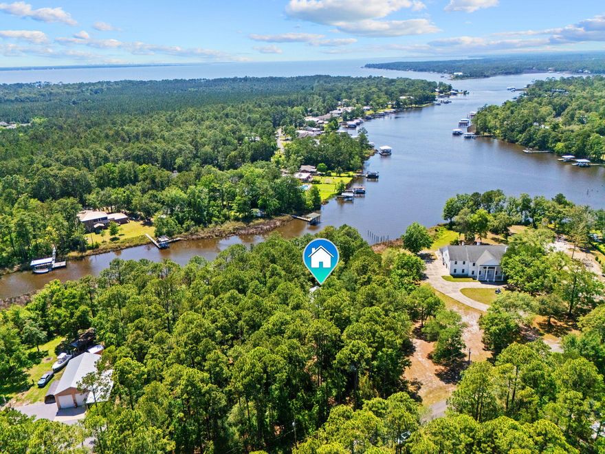 Waterfront living meets functionality and freedom at this exceptional property on Mallet Bayou Road in Freeport. Situated on beautiful Mallet Bayou with approximately 100 feet of water frontage, this property offers direct access to boating, fishing, kayaking, and enjoying the natural beauty of the bayou right from your backyard, with convenient access to Choctawhatchee Bay and the Intracoastal Waterway.

Designed for both comfort and versatility, the property features a private dock with four slips and a boat lift capable of lifting up to 3,000 lbs, making it ideal for boating and waterfront recreation. A spacious screened porch overlooks the water and provides the perfect setting for outdoor dining, entertaining, or simply taking in the peaceful views.

The home includes a wood-burning fireplace, double pane windows, foam insulation in the attic, and durable Hardie board siding. A new metal roof installed in 2024 adds long-term value and peace of mind.

In addition to the attached 2-car garage, the property offers extensive additional storage and workspace options including a detached garage/workshop, RV pole barn, carport, greenhouse, and mower shed. With no HOA and unrestricted use, the property provides flexibility for a variety of uses.

Conveniently located near Freeport amenities, marinas, dining, and the beaches of South Walton, this waterfront property combines coastal access, usable space, and practical improvements in a unique bayou-front setting.