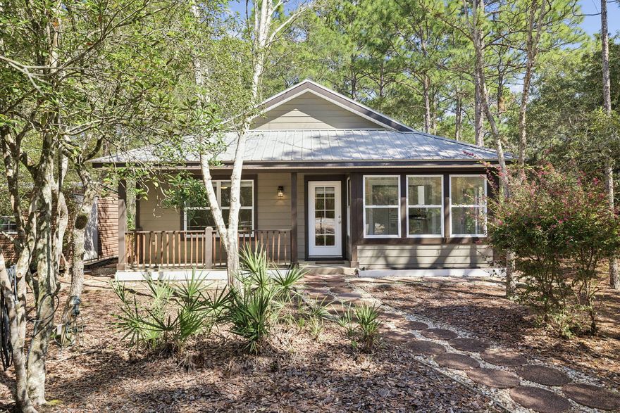 Tucked beneath a canopy of towering oaks and pines on a rare 0.96 acre lot in Point Washington, this charming 2 bedroom, 1 bath coastal cottage offers the privacy of Old Florida living just minutes from Grayton Beach and 30A. With nearly an acre of wooded land, the property provides a peaceful retreat surrounded by nature while remaining moments from the restaurants, shops, and beaches that define the 30A lifestyle. Approximately a 1.5-mile walk to Bayside Ranchettes Park, residents enjoy easy access to Choctawhatchee Bay, where sunsets, fishing from the dock, shaded picnic areas, and kayak or canoe launches are part of everyday life.

A shaded approach through mature trees sets the tone for the tranquil setting this property provides. Inside, the home features a bright, open living and dining area with an abundance of windows that frame serene forest views and invite in natural light. The spacious kitchen offers generous storage and flows into a relaxing sunroom, an ideal spot for morning coffee while taking in the surrounding landscape.

Step outside to the large screened porch, where evenings are spent listening to birdsong, watching deer wander through the property, and enjoying the quiet rhythm of life in Point Washington.

For those seeking privacy, natural surroundings, and proximity to 30A without the crowds, this property presents a rare opportunity. Whether as a full-time residence, weekend retreat, or future investment, 80 Ivy Lane captures the timeless charm of Old Florida living. Contact us for more information or a private showing.

All information is deemed reliable and provided for informational purposes; buyers are encouraged to independently verify all details.