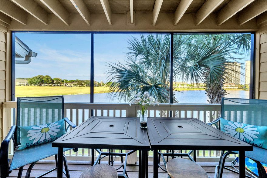 FRACTIONAL OWNERSHIP OPPORTUNITY.  Experience the best of coastal living in this two-level condo perfectly positioned for both beach days and shopping trips. With the shoreline just moments away and sweeping views over Stewart Lake and the golf course, this property delivers a rare blend of vibrant location and serene scenery. Catch a peek of the Gulf from the entry, then enjoy peaceful water views from the main living areas and both screened balconies -- the ideal mix of energy and escape. Inside, the layout is bright and open, designed for comfort. The main floor showcases a spacious living and dining area that flows effortlessly into an open kitchen featuring stainless steel appliances, generous storage, and convenient in-unit laundry. As you progress to the upper level, you are greeted by a roomy private primary suite with an oversized dual vanities, and a luxurious jetted soaking tub. Step out onto the screened balcony and take in the lake views   a perfect morning coffee spot or evening wind-down retreat. On the other side of the primary bathroom you will find a versatile bonus sleeping nook that provides extra guest space and boosts the property's appeal as a vacation or short-term rental opportunity. With screened outdoor spaces on both levels, relaxation is always within reach. Community perks include a resort-style pool, expansive beach access just steps away, and multiple recreation options such as golf, tennis, and basketball. Just minutes away, you'll find popular dining, shopping, and entertainment destinations, putting everything you want right at your fingertips. Whether you're looking for a personal coastal getaway, a full-time residence, or a high-demand rental, this condo checks every box   and then some.