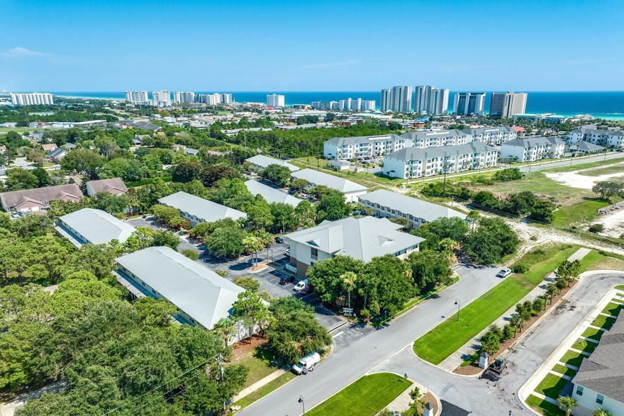Skip the Highway 98 traffic and start living! Positioned just 5 minutes from the beach and the new Publix via back roads. This move-in ready 2-bed, 2-bath condo offers a quiet escape in an intimate 18-unit building with rare elevator access.

Ideal for military (16 miles to Eglin/Hurlburt), first-time buyers, or investors maximizing long-term rentals.

Inside, enjoy an airy open plan with a tray ceiling, charming window alcove, and new carpet. The kitchen boasts fresh granite, stainless appliances, and a breakfast bar. Big-ticket peace of mind comes from PEX plumbing recently installed! Primary ensuite provides privacy and includes a built-in vanity/desk. In-unit laundry, plus washer/dryer convey.

Zero yardwork and an unbeatable location - more beach days and less traffic delays!