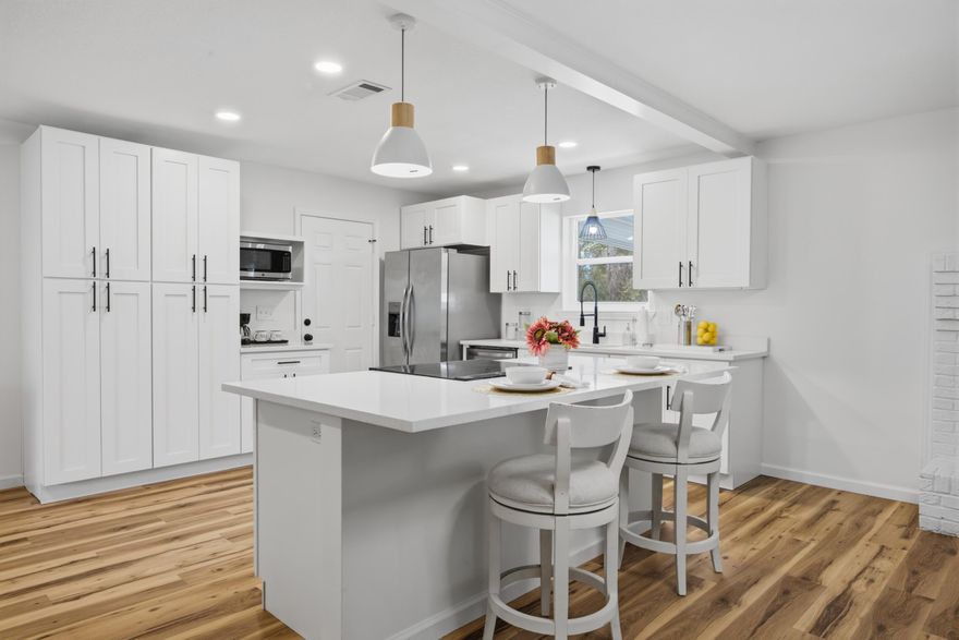 Discover modern comfort at 600 Burgundy Lane in Fort Walton Beach, where thoughtful updates and stylish finishes come together on a spacious corner lot. Inside, the home features a neutral designer color palette, luxury LVP flooring throughout, and an open-concept layout ideal for both relaxing and entertaining.

The updated kitchen serves as the heart of the home with quartz countertops, stainless steel appliances, designer lighting fixtures, and seamless flow into the living and dining areas. The living room is highlighted by a charming wood-burning fireplace, creating a warm focal point for the space.
Stylish upgrades continue throughout the home with updated bathrooms featuring tile finishes, wood vanities, and modern fixtures. Decorative, upgraded lighting add character, while new int erior paint and updated doors provide a fresh, polished look. The home also offers abundant storage with multiple closets throughout.

Step outside to enjoy the covered back porch, perfect for relaxing or hosting gatherings, along with a large powered storage shed that adds functionality and extra storage space.

Conveniently located just minutes from shopping and dining along Beal Parkway, this home is approximately 10 minutes from the white-sand beaches of Okaloosa Island and offers an easy commute to both Eglin Air Force Base and Hurlburt Field. Combining thoughtful upgrades, modern style, and a prime location, this property offers the ideal blend of comfort and convenience along the Emerald Coast.