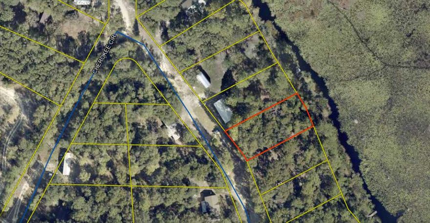 Undeveloped Parcel 0.334 acres.  Lots of potential for a small house project nestled between the old growth oak trees and gently sloping to  shoreline of Juniper lake.  Fishing, boat access, and floating dock access are possibilities.  Very quiet rural access trail (Cherokee Circle) with an Old Florida feel and surrounded by a North Walton country atmosphere.  One of the last undeveloped waterfront lots on Cherokee Circler.  Waterfront community park, with boat ramp, bathrooms and picnic table pavilions just a short distance down the paved country road.  All information deemed accurate but purchasers should verify all of importance to them.

Survey is available.