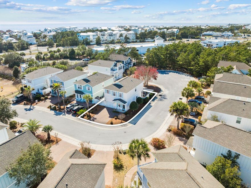 Life near the beach takes on a relaxed rhythm in this well-kept coastal home positioned on a desirable corner lot. Just minutes from the shoreline, the property offers convenient access to the beach pedestrian underpass, along with nearby restaurants and the scenic stretch of 30A easily reached by foot or bike. Designed for flexibility and comfort, the home works equally well as a primary residence, second home, or investment property in one of the most sought-after areas along the Emerald Coast. Inside, warm hardwood flooring runs throughout the first-floor living areas and continues up the staircase to the second level, adding a timeless coastal character. The open-concept layout connects the kitchen, dining area, and living room, allowing the spaces to flow naturally for both everyday  living and entertaining. The kitchen features granite countertops, wood cabinetry, and a functional layout that keeps the heart of the home connected to the surrounding gathering spaces. A convenient half bath and additional storage closets are also located on the main level, along with direct access to the single-car garage. Just off the living area, a covered patio provides a private outdoor setting for relaxing or hosting friends after a day at the beach. The fenced backyard is designed for easy maintenance with no grass to manage and includes a gate that allows guests to enter directly into the outdoor space without passing through the home. An additional storage area behind the fence along the garage side offers a practical place to keep kayaks, paddleboards, or other beach gear ready for the next adventure. All bedrooms are located on the second floor, creating a quiet and comfortable retreat from the main living areas. The primary suite features plush carpeting, a walk-in closet, and a spacious bathroom with double vanities, a soaking tub, and a separate shower. Two additional bedrooms share a Jack-and-Jill bathroom, offering both privacy and convenience for family members or guests. Positioned near the public beach pedestrian underpass and surrounded by some of the area's most sought-after coastal destinations, this well-maintained residence offers a flexible opportunity for those seeking a beachside home with strong rental potential and everyday livability along the Emerald Coast.