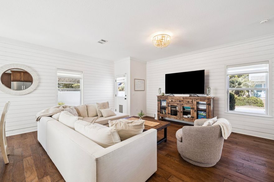 Life near the beach takes on a relaxed rhythm in this well-kept coastal home positioned on a desirable corner lot. Just minutes from the shoreline, the property offers convenient access to the beach pedestrian underpass, along with nearby restaurants and the scenic stretch of 30A easily reached by foot or bike. Designed for flexibility and comfort, the home works equally well as a primary residence, second home, or investment property in one of the most sought-after areas along the Emerald Coast. Inside, warm hardwood flooring runs throughout the first-floor living areas and continues up the staircase to the second level, adding a timeless coastal character. The open-concept layout connects the kitchen, dining area, and living room, allowing the spaces to flow naturally for both everyday  living and entertaining. The kitchen features granite countertops, wood cabinetry, and a functional layout that keeps the heart of the home connected to the surrounding gathering spaces. A convenient half bath and additional storage closets are also located on the main level, along with direct access to the single-car garage. Just off the living area, a covered patio provides a private outdoor setting for relaxing or hosting friends after a day at the beach. The fenced backyard is designed for easy maintenance with no grass to manage and includes a gate that allows guests to enter directly into the outdoor space without passing through the home. An additional storage area behind the fence along the garage side offers a practical place to keep kayaks, paddleboards, or other beach gear ready for the next adventure. All bedrooms are located on the second floor, creating a quiet and comfortable retreat from the main living areas. The primary suite features plush carpeting, a walk-in closet, and a spacious bathroom with double vanities, a soaking tub, and a separate shower. Two additional bedrooms share a Jack-and-Jill bathroom, offering both privacy and convenience for family members or guests. Positioned near the public beach pedestrian underpass and surrounded by some of the area's most sought-after coastal destinations, this well-maintained residence offers a flexible opportunity for those seeking a beachside home with strong rental potential and everyday livability along the Emerald Coast.