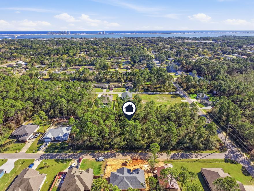 Build your dream home on this beautiful vacant lot with no HOA restrictions. Conveniently located just minutes from Navarre's sugar-white beaches, local restaurants, schools and Publix. Enjoy nearby attractions like Navarre Park, which features playground and splash pad. Spend the day fishing or taking in the Gulf views at the Navarre Beach Fishing Pier or explore marine life and conservation efforts at Navarre Beach Sea Turtle Conservation Center. This almost half acre lot will need to be cleared, offering the opportunity to preserve the shade trees you desire while designing the perfect homesite. Buyer to verify all pertinent information.