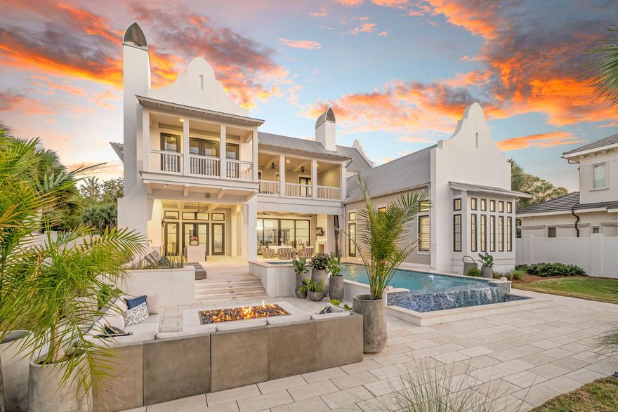 Privately positioned on over 1.03 bayfront acres in Miramar Beach, 510 Walton Way is a rare coastal estate where refined architecture, discretion, and direct water access come together. Set behind a gated entrance, the residence was thoughtfully designed by Geoff Chick and constructed by Chase Green Built to feel both expansive and deeply private, with open water views serving as the backdrop throughout.

Inside, soaring ceilings, custom coffered details, and large scale sliding glass doors create a seamless connection between the main living spaces and the bayfront terrace. The chef's kitchen is designed for effortless entertaining with dual oversized islands, a professional gas range, custom cabinetry, wine refrigeration, a butler's pantry, and an architectural range hood that anchors the space beautifully.

Upstairs, the home transitions into a private entertainment level where the lounge, wet bar, and covered balcony overlooking the bay connect directly to a 10-seat raised luxury theater with 7.1 surround sound. A custom bunk room, additional ensuite bedrooms, and a plumbed bonus space offer flexibility for guests, extended stays, or future private suite use.

Outdoors, the property lives like a private resort with an infinity edge saltwater pool and spa, covered outdoor living and dining, full summer kitchen, sun deck, bayfront sauna, and private dock with boat lift and two jet ski lifts. Built with long-term coastal living in mind, the home features 60% concrete block construction, hurricane impact windows, a whole house dehumidifier system, and an elevator shaft in place for a future elevator.

With gated privacy by land and immediate access by water, this is one of Miramar Beach's most distinctive bayfront offerings.