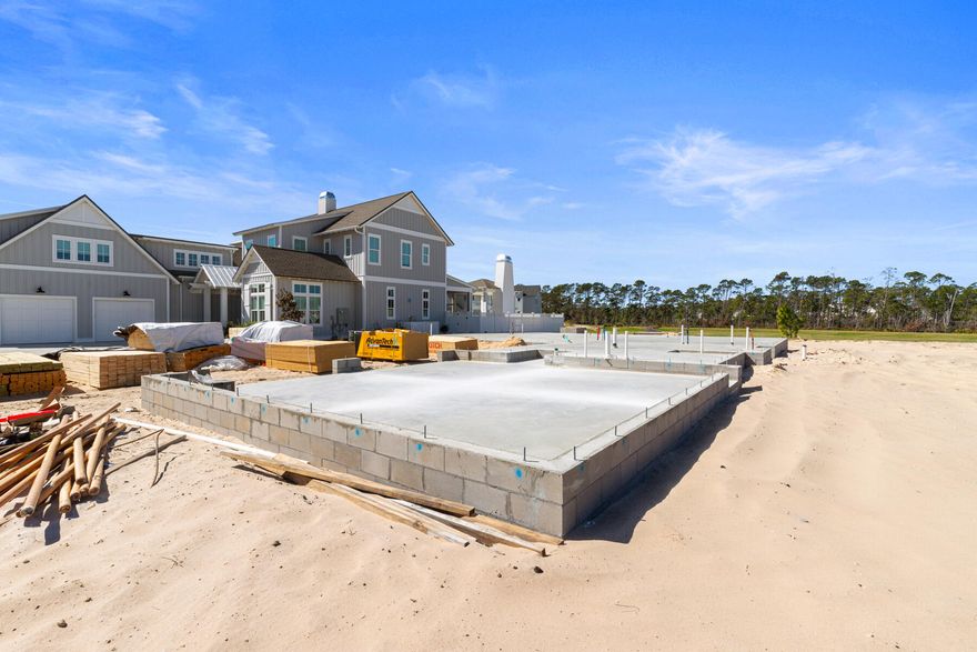 Currently in framing! April progress photos coming next week.

The Darien III by Romair is a custom residence with a detached carriage house, offering 4,775 square feet, 5 bedrooms, 5 bathrooms, 2 half baths, and a 2-car garage, located on a Homesite backing up to vast dry pond area in Powell Landing East at Watersound Origins.

The first level is arranged with clearly defined spaces, beginning with a dedicated dining room that includes a built-in wet bar and undercounter wine refrigeration. The kitchen is positioned at the rear of the home, opening directly to the covered porch and summer kitchen, creating a direct connection to the outdoor living areas and pool courtyard . The adjacent living room features a fireplace and 16 foot slider doors that open fully to the exterior, extending the living space outward. Twelve-foot ceilings throughout the main level reinforce the scale of each space without sacrificing proportion.

The owner's suite is located on the main level with French doors leading directly to the pool and spa. The bath includes a walk-in shower with upgraded rain fixture shower head and free-standing soaking tub, along with a spacious custom closet designed with a center island for additional storage and organization .

Functional spaces are equally considered. The laundry room includes built-in cabinetry, a sink, a dedicated broom closet, and a bench with cubbies for everyday use. Circulation between the garage, mudroom areas, and main living spaces is efficient and separate from guest-facing areas.

The second level provides additional bedrooms and a secondary living space, offering separation from the main level while maintaining connection through a central stair hall. Ten-foot ceilings continue throughout the upper level, maintaining consistent volume and scale. Above the garage, the carriage house includes a kitchenette, living area, bedroom, and bath with its own access, suitable for guests or extended stays.

The outdoor environment is fully integrated into the plan. A heated saltwater pool and spa with baja deck are set within a paver pool deck and enclosed by fencing, all managed by a WiFi-enabled pool controller. The cabana with fireplace anchors the space, while the dedicated outdoor kitchen connected to the main house is equipped with an Artisan grill with stainless steel doors, U-Line outdoor refrigerator, and sink.

Interior finishes include white oak cabinetry with stained overlay throughout, along with upgraded quartz surfaces and upgraded Delta plumbing fixtures. The home is equipped with a Water and Air Wellness Package, including a whole-house water softener, reverse osmosis system, REME Halo air cleaner, and an added integrated leak detection system.

Additional features include a tankless water heater and detailed interior trim consistent with the overall architectural design.

Estimated completion:  2026

As part of Watersound Origins, often called "A Coastal Village," residents relish abundant amenities like the Village Commons resort-style pool, fitness center, sports courts, miles of nature trails, event lawns, and the Origins Golf Course. Surrounded by towering pines and just minutes from Lake Powell and the beaches of Scenic Highway 30A, this community blends natural beauty with easy access to Inlet Beach, Grayton Beach, and beyond. Upcoming highlights include the 15.5-acre Longleaf Art Park, opening in 2027, featuring cultural and recreational experiences.