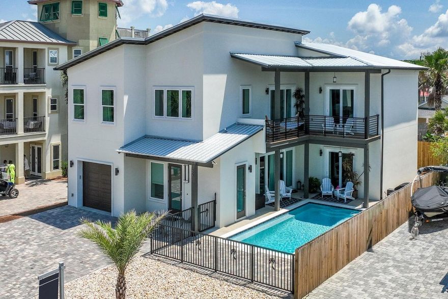 STUNNING CUSTOM HOME NEW IN 2022, POURED SOLID CONCRETE WALLS. NO HOA FEES IN PRESTIGIOUS FRANGISTA BEACH.  Only a 5 minute walk to a deeded beach access. Walk into a 28-foot Foyer with open floor plan. See the sparkles from the chandelier when sun lights it up. Each bedroom has its own ENSUITE.  PRIMARY ON MAIN WITH POOL VIEWS.  Kitchen is to die for with Chefs Kitchen and appliances with amazing surprise addons!
A 50lbs. built in ice machine keeps Parties Alive in the heated Salt Water pool with a 25 foot inside pool bench. Large open pocketed impact slider doors on both levels. Cost to Own a Concrete Home is MINIMAL AND WILL BE THE HOME WITH NO YEARLY WOOD ROT, HIGH INSURANCE OR ELECTRIC BILLS.  

NO HOA!  NO HOA!