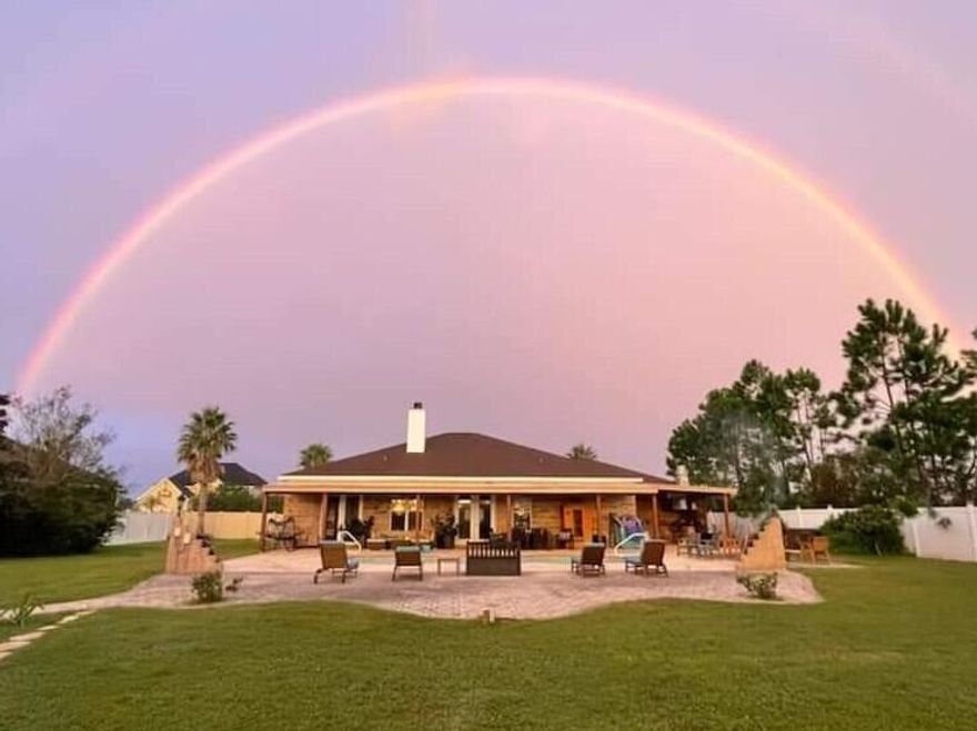 SOMEWHERE UNDER THE RAINBOW... Beautiful custom home situated on over a half-acre lot in a quiet, private community of Kirkland Manor surrounded by natural spring-fed ponds. This thoughtfully designed home features an open floor plan with spacious living areas perfect for both everyday living and entertaining.
The primary suite offers a peaceful retreat with an ensuite overlooking the backyard and pool area. On the opposite side of the home, two additional bedrooms provide comfort and privacy for family or guests. A dedicated game area and wet bar just off the pool create the ideal setup for hosting and relaxing.  Plus an additional room for an office or work out area.
Step outside to enjoy true Florida living with expansive outdoor spaces, a sparkling pool, and plenty of room to unwind.  Enjoy fresh fruit from your garden of established fruit trees and bushes!                                      
The detached guest house with a separate entrance offers endless possibilities -- perfect for a studio, home office, private guest suite, or mother-in-law quarters.
Located in a highly desirable community known for its custom homes and scenic ponds, this property combines privacy and tranquility while remaining conveniently close to shopping, dining, schools, and everything the area has to offer.