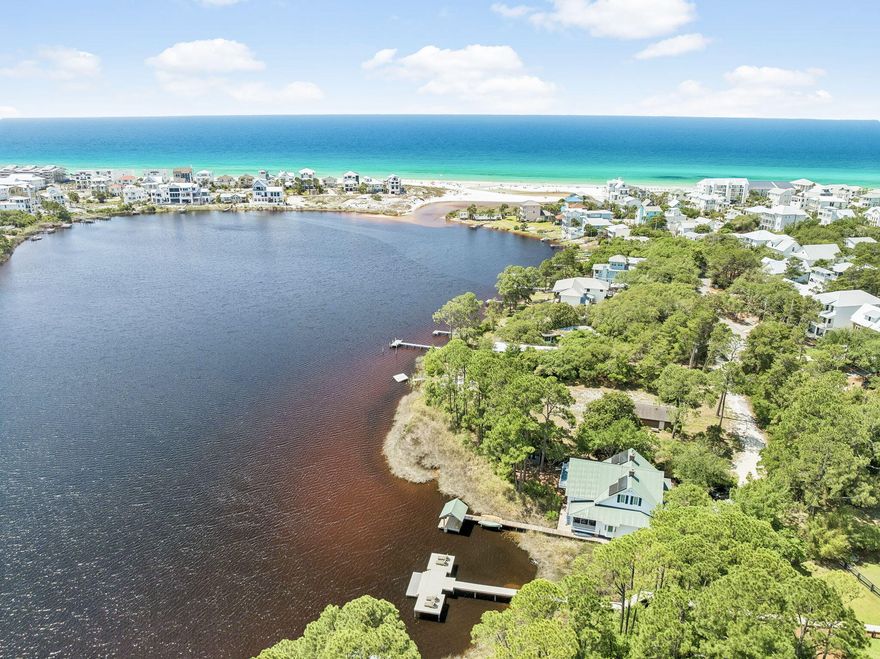 Newer Home on Eastern Lake with new dock and the beach just 200 yards away, this Seagrove Beach retreat delivers the quintessential 30A experience. Built in 2022, the 3,754 sq ft home offers five bedrooms, sleeps 12-14 with ease. Shiplap walls, wood floors, soaring ceilings and custom cabinetry set a refined coastal tone throughout. Four ensuite bedrooms plus a bunk room which sleeps 4 create flexible, guest-ready living, while open dining and kitchen spaces accommodate 10 at the table and four at the bar. Outside, a heated pool, expansive deck, large fenced yard and dock invite morning coffee by the water and evening swims under open sky. A two-car garage, smart TVs throughout and proximity to dining, shopping and beach access complete this rare lakefront offering in the heart of Seagrove Beach.