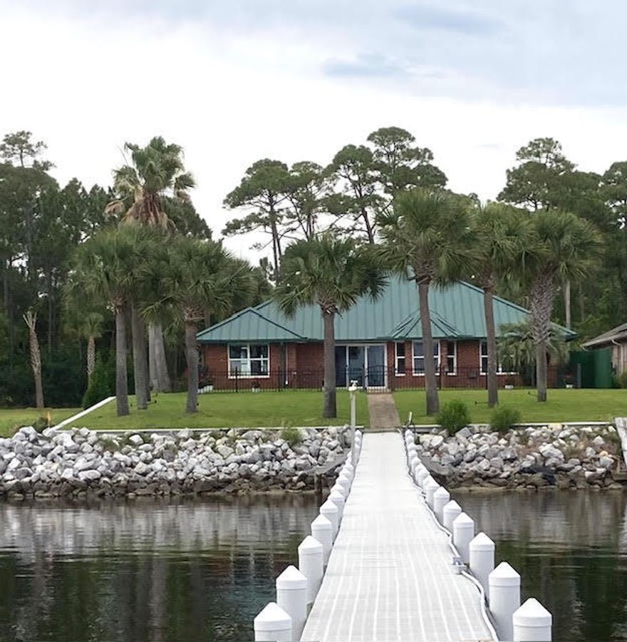 NO HOA
Kitchen cabinets updated
Sewer and Public Water, GAS, Florida Power and Light, Underground utilities
NOBSTRUCTED MILLION DOLLAR VIEWS  
PIER with 250+ ft  of FLOW THRU DECKING, WATER AND POWER 
2 BOAT LIFTS 
(20,000 and 5,000 pounds)
IRRIGATION SYSTEM with Private
Well, Pump and Sprinklers 
Unique Split Bedroom Floor Plan with 4 BEDROOMS, 3 BATHS, could possibly be 5th bedroom, or Multipurpose Room with Private entrance, DAIKEN heating and cooling, & cabinets,
GUEST ROOM w/Private entrance and bath. 
Lots of NATURAL LIGHTING THROUGHOUT.   TILED, Ceiling Fans, Hurricane Shutters, Metal Roof, On Demand Hot Water Heater, Pella Windows in main portion of house South of Laundry Room.
HANDY MANS Wonderland
w/storage cabinets, 220, hot/cold running water, climate control and polyurea flooring
SURVEY, ELEVATION CERTIFICATE, HOME INSPECTION ACCOMPLISHED. Boat or RV Parking.
LOTS OF ROOM to PADDLE BOARD, CANOE or SAIL.
NEW ELECTRIC FIREPLACE. NEW HARDWARE. Termite Bond Transferable.  
DOCUMENTS SHOW County Flood Zone map.  Delineation of flood zone goes around the house. 
All BRICK HOME was rebuilt in early 2000's. METAL ROOF, GUTTERS, Exterior Shower, Fenced Patio, Fresh Paint, Knockdown Textured Ceilings, Tiled throughout, Ceiling Fans, attic duct work replaced, Windows replaced in 2005 & gas tankless water heater.   WEST WING has a guest room, bath and PRIVATE GUEST SUITE with handicap shower features, Separate Entrance with pet door leading to fenced patio with Water View. 
LARGE MASTER BEDROOM is on the EAST SIDE with WATER VIEWS from bath and bedroom.  Master Bath offers Cultured Marble JETTED TUB, Separate shower, Double Vanities, Linen Closet and Private Commode. FOURTH BEDROOM IDEAL FOR a Private Office, Nursery, Library, Children's Area, Sewing Room or Guest Room.
KITCHEN has plenty of granite counter space, pull out pantry shelves, pull out lower shelving, wine glass rack, microwave, STAINLESS STEEL APPIANCES, NEW REFRIGERATOR and STOVE, accent lighting under the bar.  Kitchen overlooks the Bay Window Seating and into the Living Room with space for a formal dining suite.  The kitchen cabinets will be refurbished and new back splash in late March, Early April.
Motion Sensor exterior lights and accent lighting on the palms, Water shut off to the pier and Outdoor shower.  Buy a lot in Holley by the Sea and utilize the Recreational Center with year-round  swimming in the enclosed lap pool, outdoor family pool, Million Dollar work out room, tennis courts, deeded water access, camping, social club and much more. (HOA DUES approximately $550 year). 
PARADISE AWAITS YOU.