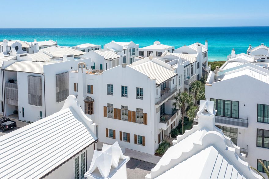 Where the Gulf of Mexico meets refined coastal architecture, 130 Sea Garden Street stands as a KVA Architecture masterpiece in prestigious Alys Beach. Located on the renowned Turtle Bale Pedestrian Path, just steps from the beach, this exquisite 5-bedroom, 5.5-bathroom residence spans 3,865 square feet across four living levels, offering breathtaking Gulf views.

Upon entering, you are greeted by Italian Limestone flooring and a striking Venetian Plaster staircase, setting the tone for this impeccably detailed home. A wide-body staircase and private elevator provide seamless access to all levels. Two elegantly appointed guest suites, featuring beverage drawers and custom wormy oak accents, create a welcoming atmosphere for visitors.

The second floor showcases the heart of the home, where 12-foot scalloped ceilings with recessed reclaimed oak beams evoke the gentle waves of the Gulf. The open-concept living area integrates dining, kitchen, and living spaces, anchored by herringbone oak floors and Leuders limestone countertops. The chef's kitchen is a culinary dream, equipped with Sub-Zero, Wolf, and Miele appliances, custom cabinetry, and a butler's pantry complete with an espresso machine, wine refrigerator, and mixology station. Expansive ten-foot accordion Loewen doors dissolve the boundary between indoor and outdoor spaces, inviting stunning Gulf views into the living area.

A covered loggia extends the living experience outdoors, featuring a fireplace, dining area, and summer kitchen that flows directly into the swimming pool to gaze at the Gulf of Mexico--perfect for entertaining.

On the third floor, an additional guest bedroom with dual vanities and a walk-in shower complements the primary suite, which is bathed in natural light. Floor-to-ceiling windows open to a private balcony offering captivating Gulf views, while the master bath is adorned with mosaic tiles and limestone slabs. A spacious walk-in closet with custom oak cabinetry enhances the suite, along with a convenient in-room Miele coffee station.

The fifth bedroom has been transformed into a versatile media lounge, ideal for movie nights or accommodating overnight guests. The home features a comprehensive Control4 automation system, managing lighting, music, security monitoring, video intercom, and more. The rooftop terrace captures unobstructed Gulf views and showcases the award-winning architecture of Alys Beach.