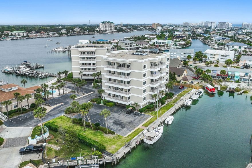 Waterfront Living on Holiday Isle with Direct Gulf Access! Renovated 2BR/2BA condo at Sun King Towers overlooking the canal. This bright second-floor unit features an updated kitchen with quartz countertops, newer appliances, in-unit washer/dryer, and hurricane-impact windows and doors. Enjoy two private covered balconies with peaceful water views. Gated community with waterfront pool and unique two-story pool house with kitchen and gathering space. Boat slips available first-come for just $500/year including water and electric. Just a 10-minute walk to Destin's white-sand beaches. Ideal as a primary, vacation home, or investment property.