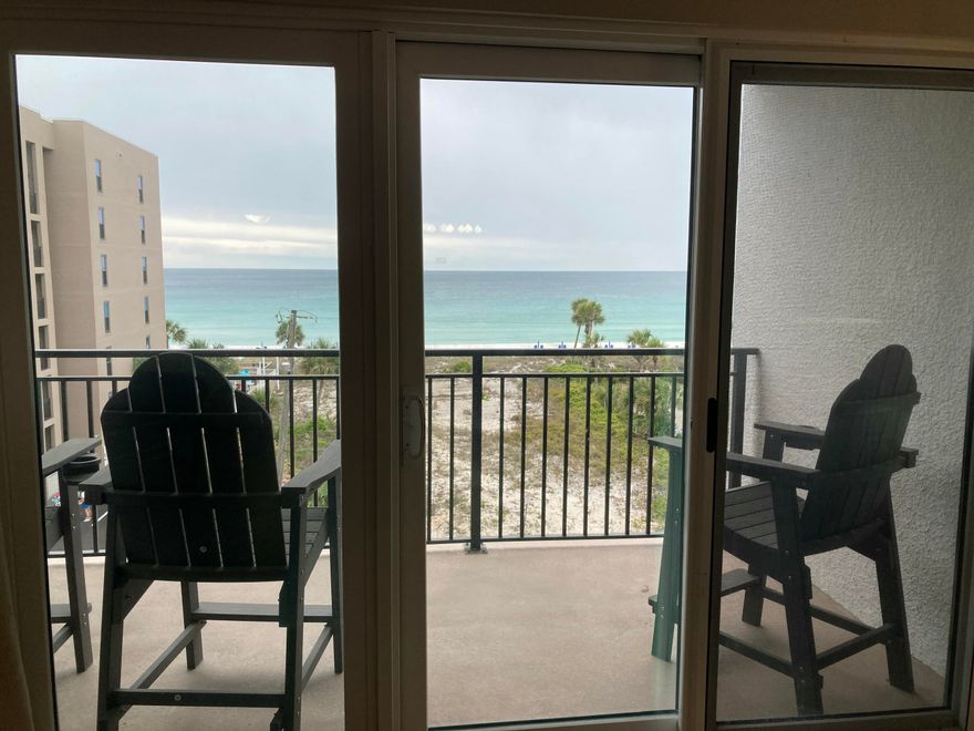 Check out this freshly painted, well maintained 5th floor unit that is beautifully decorated in a beachy vibe and has stunning views of the emerald green waters of the Gulf.  Emerald Isle is located on the white sand beaches of the Emerald Coast of Florida and offers not only the beautiful beach but also a Gulf front pool, BBQ area and a tennis/pickle ball court.  No need to bring your sandy beach equipment up to the unit. Instead, use the convenient storage cage on the ground floor that conveys with the unit. Emerald Isle Condominium recently completed a multimillion-dollar restoration to the building to include repairing concrete, waterproofing and painting the building, elevators, replacing railings and resurfacing the parking lot. Buyer to verify all dimensions and square footage.