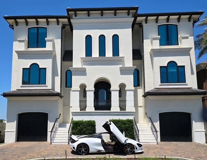 Anchoring the Downtown Pensacola bayfront, this 2018-built waterfront home is in like new condition and one of the few that truly delivers on both design and fortified construction. With approximately 8,000 square feet under roof (5,200+ heated and cooled, 1,400 of conditioned 4 car garage space, approximately 1500 sq. ft of covered and finished exterior decks).  What sets it apart is what you don't always see. Concrete and 2x8 construction, a 50-year concrete tile roof by Boral, and built to full high-velocity wind zone standards. Up to 10 ft tall HVWZ 'High Velocity Wind Zone' doors and windows from Kolbe & Kolbe which are engineered for up to 200 mph wind zone.
