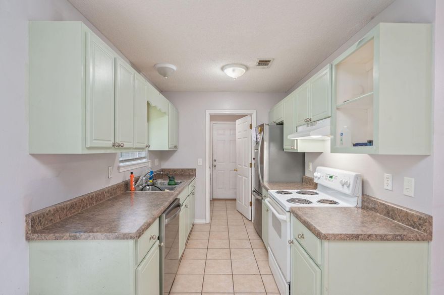 Popular split bedroom floor plan. The Living Room, Dining Area, Kitchen and Bathrooms have tiled flooring. Bedrooms are carpeted.  Front porch and open back patio. 1-Car garage. There is an extra parking pad along the side of the driveway. Inside Laundry Room. Quiet neighborhood in town!
