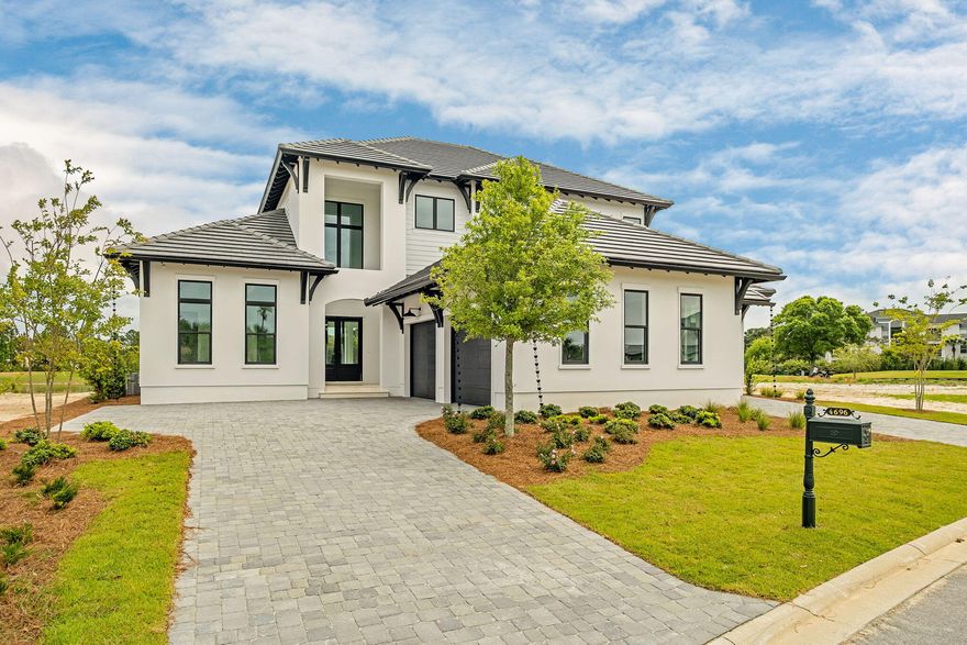 Located within the elevated Regatta Bay Golf & Yacht Club, this newly constructed residence by the renowned Boswell Builders exemplifies refined coastal luxury and exceptional craftsmanship. Perfectly positioned near the front of the community for ease of access, this home offers both privacy and convenience within one of Destin's most sought-after gated neighborhoods.

Regatta Bay is known for its world-class amenities, including a championship golf course, private marina access, tennis courts, walking trails, and a beautifully appointed clubhouse--delivering a resort-style lifestyle just minutes from the Gulf.

Inside, every detail has been thoughtfully curated. The chef's kitchen is anchored by a stunning 10-foot waterfall island and outfitted with premium appliances including a Sub-Zero refrigerator, Wolf gas cooktop, and Wolf double ovens, complemented by an additional full-size refrigerator in the expansive butler's pantry. Entertain effortlessly with a dedicated wine room featuring a 151-bottle dual-zone wine refrigerator.

The open-concept living space flows seamlessly to a fully climate-controlled outdoor living area, complete with a gas fireplace, vaulted wood ceilings, and a summer kitchen featuring a Coyote gas grill. Designed for year-round enjoyment, this space opens entirely to the backyard, where a heated custom pool and spa are surrounded by elegant white ivory travertine pavers and an oversized lanai ideal for dining and gatherings.

The primary suite is a private retreat, showcasing an architecturally striking tray ceiling, dual oversized walk-in closets, and a spa-like bath with a garden tub, dual-entry shower, and rare his-and-hers separate toilet rooms--an elevated feature seldom found even in luxury homes. A dedicated office provides a quiet workspace, while crown molding and a custom lighting package enhance the home's sophisticated aesthetic throughout.

Upstairs, a secondary living area opens to a balcony with lovely water views overlooking the Regatta Bay golf course. Three spacious guest suites, each with en suite baths, and a large storage room complete the second level.

Additional highlights include a 3-car garage, Scotsman nugget ice maker, and impeccable attention to detail at every turn.

This is a rare opportunity to own a truly exceptional new construction home in one of Destin's premier luxury communities.