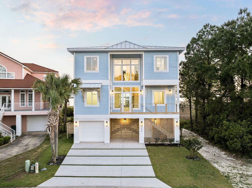 Stunning coastal new construction in a gated cul-de-sac waterfront setting with private sand beach and dock (permit in final stage). This 5BR + office, 4.5BA home features PGT hurricane windows/doors, white metal roof, Hardie board siding, and wood pilings with cross-bracing. Interior boasts white oak floors, Crossville tile baths, designer mosaics, and luxury stones including Bianco Impala marble, Cristallo quartzite, and Carrara marble. Chef's kitchen with Forno gas range and SS appliances. Grand 21' entry with statement chandelier, wine display, and custom millwork. Navien tankless WH, app-controlled irrigation, outdoor shower, large garage, and room for a pool complete this coastal retreat.