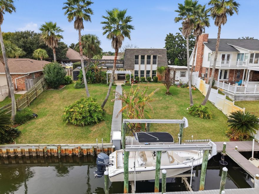 Under Contract with home sale contingency and Kick-Out Clause.  Deep water canal-front home in Gulf Breeze  Featured on popular YouTube Channel 'AnglerUp with Brant'! Boating enthusiasts will love the private dock with a boat lift for a 30+foot boat up to 20,000 lbs, positioned on a deep water canal just minutes to open water for effortless access to endless adventures.  This home offers comfortable living areas and flexible space with a versatile bonus room perfect for guests, a home office, or entertainment space. Enjoy seamless indoor-outdoor living with a huge upper deck ideal for relaxing or entertaining, plus an outdoor shower room for convenience after a day on the water. Located in a golf-cart friendly community with access to Tiger Point Golf Club, and a short commute to local restaurants and shops.