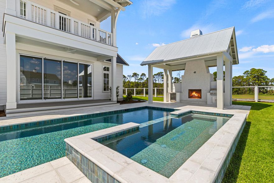 The Cove plan in the Powell Landing East neighborhood of Watersound Origins offers 4,326 square feet with 6 bedrooms, 6 full bathrooms, 2 half baths, and a separate carriage house above the 2-car garage with additional bay for a golf cart. Positioned around a private outdoor courtyard, the layout is designed to balance gathering spaces with private guest accommodations.

The exterior combines clean coastal architecture with board and batten siding, multiple covered porches, exposed brackets, and expansive window lines . A large heated pool and spa anchor the outdoor living area, complemented by a sunshelf, covered outdoor living space, and dedicated pool bath.

The main living area opens toward the courtyard through large glass openings, connecting the living, dining, and outdoor spaces into a central gathering area. The kitchen is positioned at the center of the home with an oversized island, walk-in pantry, and direct connection to both indoor and outdoor entertaining spaces.

The primary suite occupies a private wing on the first floor and includes direct access to the outdoor living area, dual walk-in closets, a freestanding tub, separate shower, and dedicated dressing space. Additional guest suites are distributed across both levels, each with private bath access and walk-in storage. The second floor includes additional bedroom suites, loft-style gathering spaces, covered porch access, and elevated views overlooking the pool courtyard. Above the garage, the carriage house provides a separate living environment complete with a private bedroom, full bathroom, great room, and full-size kitchen appliances, making it well suited for long-term guests or multi-generational living .

Located within Powell Landing East, residents enjoy access to Watersound Origins amenities including the Origins Golf Course, Village Commons pool and fitness center, miles of trails, and convenient access to Lake Powell, 30A, and the Watersound Town Center.