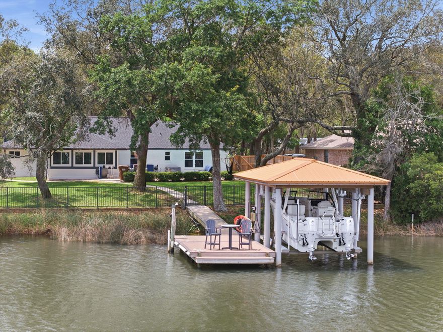 Tucked beneath a canopy of mature oak trees along the peaceful Bay location - this extraordinary waterfront residence is the definition of refined coastal living--where thoughtful design meets uncompromising quality and every detail has already been elevated for the next owner.

From the moment you arrive, the presence is undeniable. A newly completed driveway, sidewalk, and dedicated boat trailer parking pad (2023) set the tone, while the exterior showcases durable James Hardie board siding (2021), new gutters (2022), and a 30-year architectural roof (2022). Step inside and you'll immediately feel the care and craftsmanship poured into this home--every interior door, trim piece, and hardware selection has been completely updated, creating a cohesive and elevated aesthetic throughout. The heart of the home is a fully reimagined kitchen, taken down to the studs and expanded in 2022 to create a true gathering space. Outfitted with premium GE Café appliances, a Silgranite sink, soft-close cabinetry, granite surfaces, and stunning shiplap ceilings, this space seamlessly connects to a walk-in pantry and thoughtfully designed office (or optional 5th bedroom) with its own walk-in closet. The adjacent laundry room was also relocated and redesigned for maximum functionality.

Designed with flexibility in mind, the home features two luxurious primary suites--including a private upstairs retreat added in 2022 above the newly constructed garage. This suite is a sanctuary of its own, complete with a dedicated HVAC system, 50-gallon water heater, and the ability to be fully isolated from the rest of the home--perfect for guests, multigenerational living, or ultimate privacy.

Step outside and experience true waterfront living. The backyard is fully fenced (2025) with convenient dog door access, leading you to a beautifully maintained outdoor space complete with a resurfaced pool (2025), upgraded multi-stage pump, and saltwater system (2022). The composite dock (2021) and professionally constructed boathouse by Northwest Marine (2022) are nothing short of exceptional--featuring ECO piles, power and water, and a 12,000 lb lift, all set on deep water capable of accommodating larger vessels. This is a rare opportunity for boating enthusiasts seeking both function and durability.

Every major system in this home has been addressed with intention and longevity in mind. Highlights include:

High-impact hurricane windows (2022)
Complete HVAC replacement with insulated ductwork to current code (2022)
Additional 100-amp electrical service, new panels, and EV charging readiness in the garage (2022)
Full PEX plumbing conversion and new water main with protective sleeve (2022)
Whole-home water filtration system (2022)
R38 blown-in insulation for enhanced efficiency
4-zone irrigation system with private well
Additional recent updates include fresh carpet (2026), updated secondary bathroom fixtures (2026), regrouted shower (2026), upgraded sunroom ceiling (2025), and continued pest protection with a transferable termite bond through Arrow Exterminators.

Beyond the home itself, the location is equally compelling. Centrally positioned for easy access to Pensacola, Fort Walton Beach, and Highway 87 for quick interstate travel--this property offers both convenience and tranquility. With no HOA, a setting rich in natural beauty, and deep-water access that's increasingly difficult to find, this is truly a standout offering along the Emerald Coast.

This is more than a home--it's a meticulously upgraded waterfront retreat where every improvement has already been made, allowing you to simply arrive, exhale, and enjoy the lifestyle.